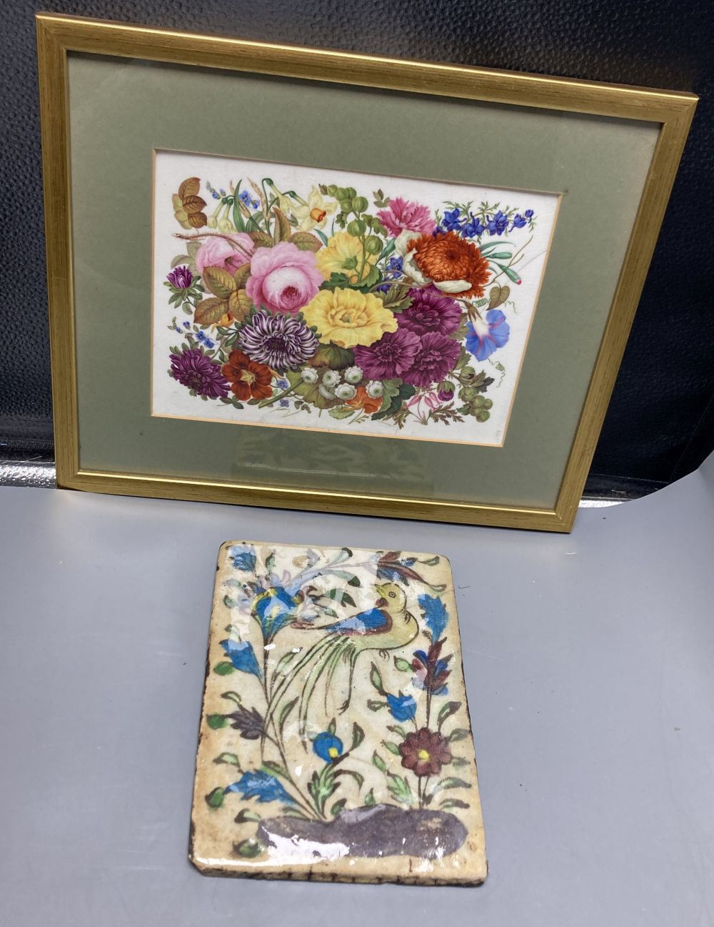 An English porcelain flower painted plaque, c.1830, 16.5 x 23cm and a Persian Qajar tile